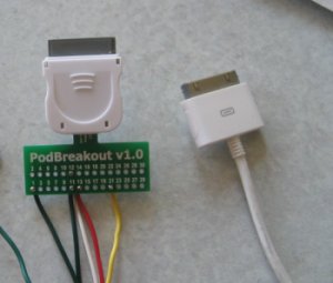 Picture of our iPod PCB next to a normal iPod USB cable